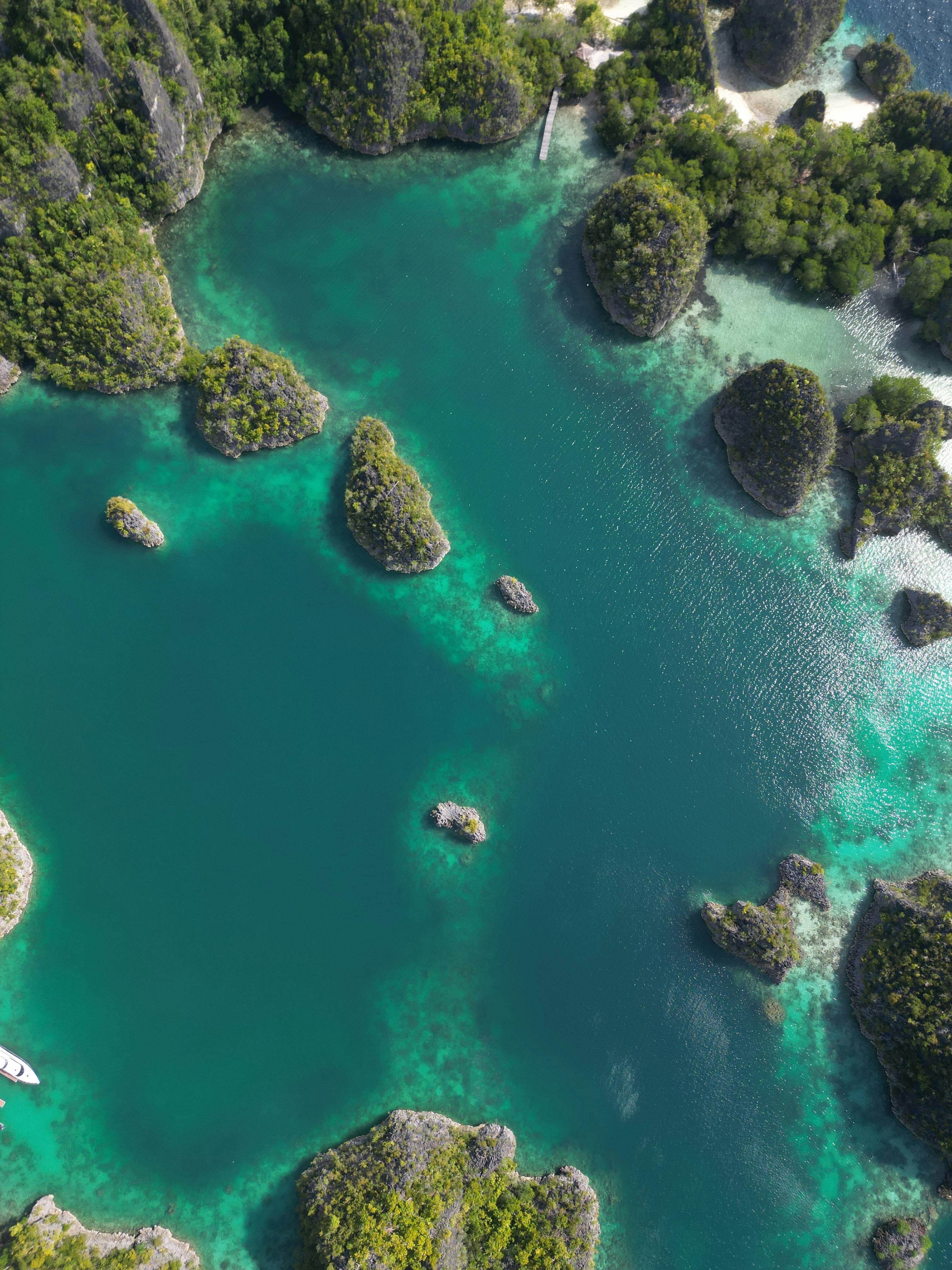 Jumping into crystal-clear turquoise waters off the coast of Greece