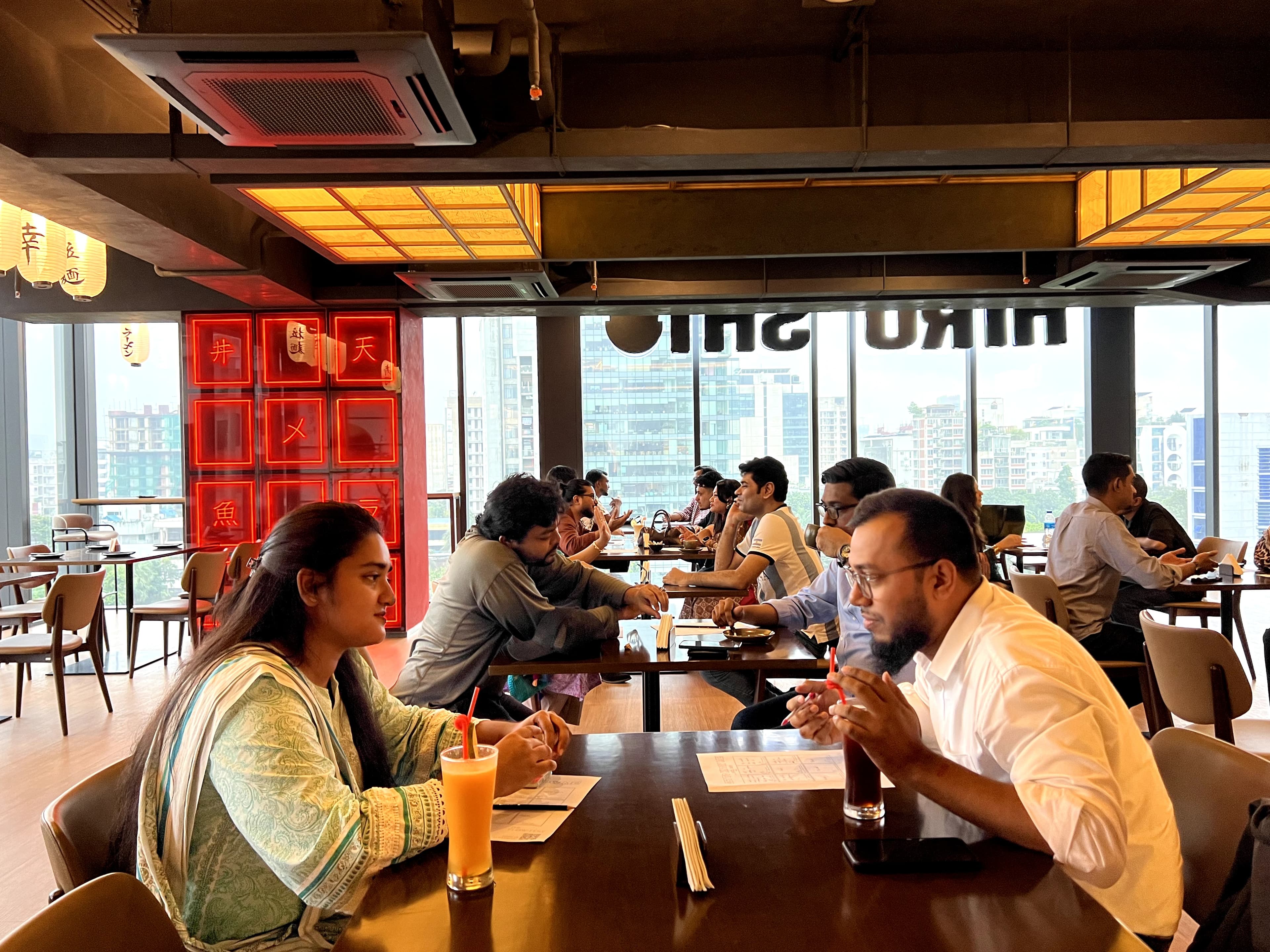 Pairs seated with prompt cards at Hiroshi Ramen